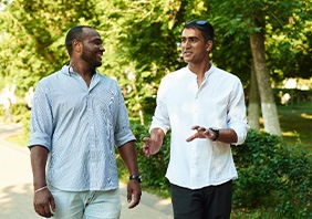 Two men walking and talking outside
