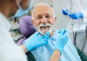 Older man with white hair about to undergo dental exam