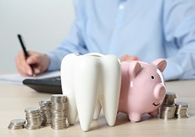 Coins next to a piggy bank