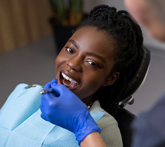 Male dental patient smiling and talking to dentist