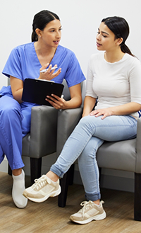 Filling out form on clipboard with pen