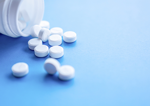 Close-up of pills poured out of bottle