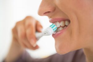 Close-up of person brushing their teeth.